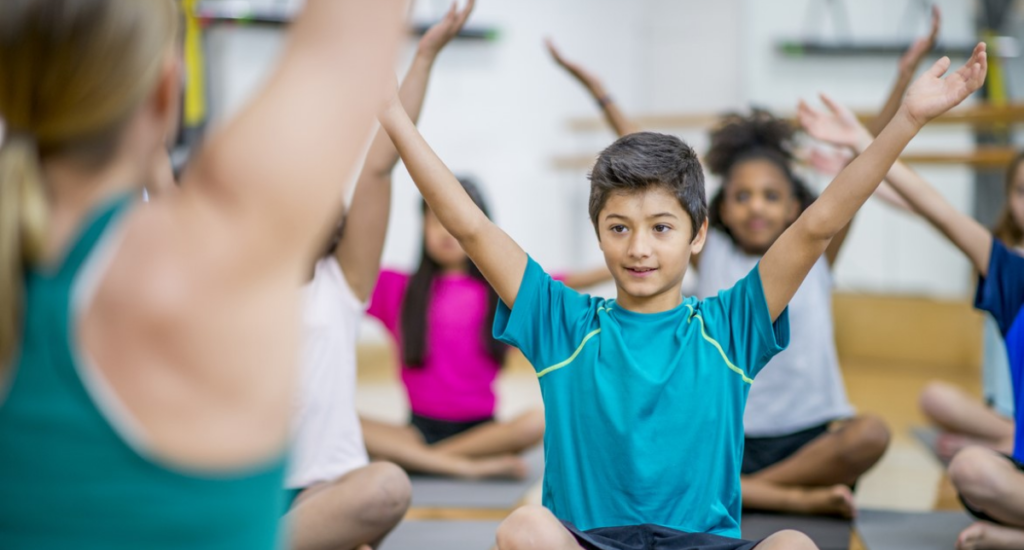 Kids practicing swimming, karate, and yoga at an international school for development